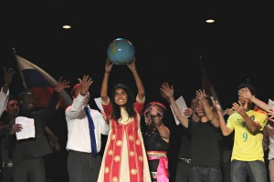 International Club Members sing and dance to "We are the World," a Michael Jackson and USA for Africa song. Audience members stood to applaud the organization.