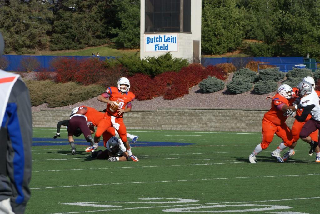 Senior quarterback John Kelly avoids a third-quarter sack against UW-La Crosse Nov. 9. Kelly helped the Pioneers secure their eighth win of the season with 250 yards and a touchdown.