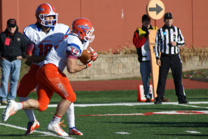 Sr. QB John Kelly (18) hands off to Jr. RB Andy Puccini (32).