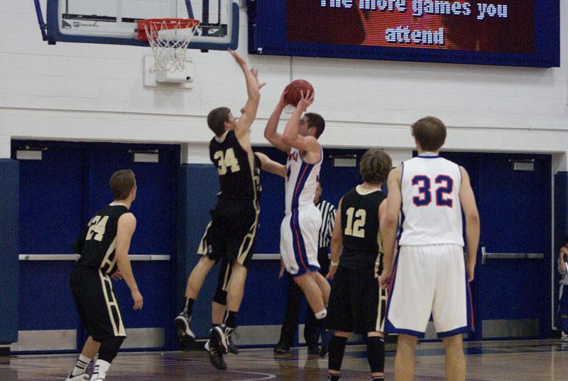 Junior forward Jake Manning (34) is fouled on a layup in the first half against St. Olaf Nov. 24. The Pioneers lost the game 68-62, after scoring just 22 points in the second half. As of Tuesday, the Pioneers are 4-2 on the season.