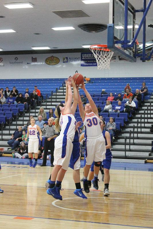 Pioneer junior forwards Alyssa Krajco (30) and Stacy Clark (21) contest for a rebound in an 81-77 overtime victory against Marian Nov. 22 Krajco and Clark are first and second, respectively, on the Pioneers in points and rebounds.