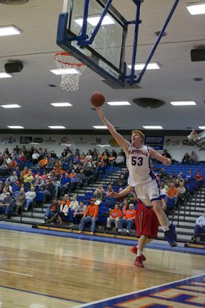 Senior center Chas Cross absorbs contact and makes a layup. 