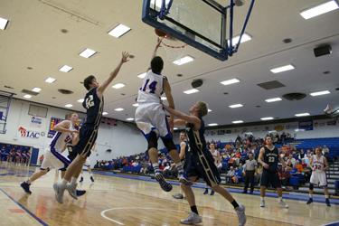 Boston Johnson (14) beats two defenders for a bucket.