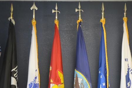 Various veteran flags are displayed in the Veterans Center, honoring those who served in the United States military.