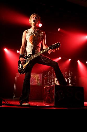 Black Stone Cherry's lead guitarist rocks out on stage.