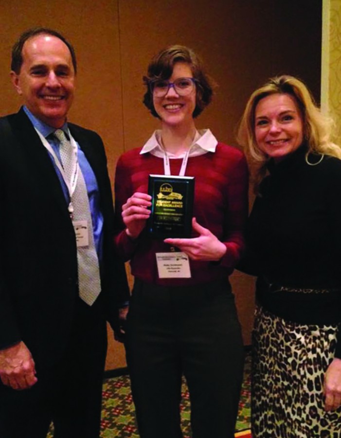 Molly Christenson, media studies major, poses with keynote speaker Steve Boettcher and President and CEO of Wisconsin Broadcasters Association in Madison Michelle Vetterkind at a seminar in February. 