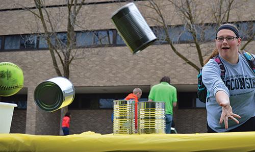 Amanda Becher senior industrial technology management major plays Can Knock-Down at the Earth Day carnival.