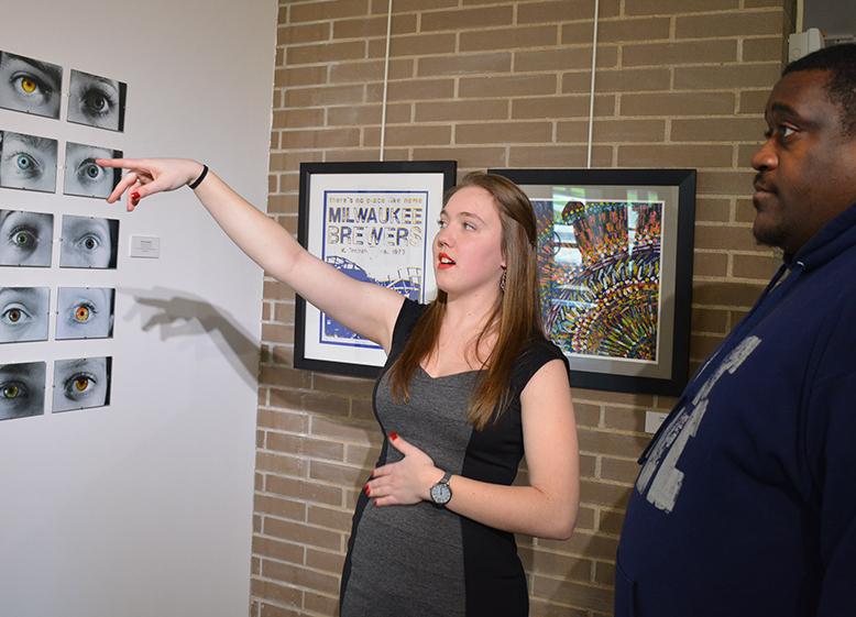 Holly Nygaard, senior graphic design major shows one of her projects, which is a collage of eyes with heterochromia.