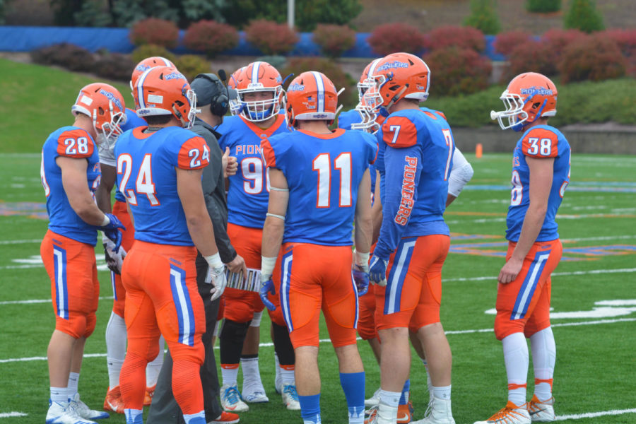 The Pioneers huddle together during a time out to discuss their strategy.