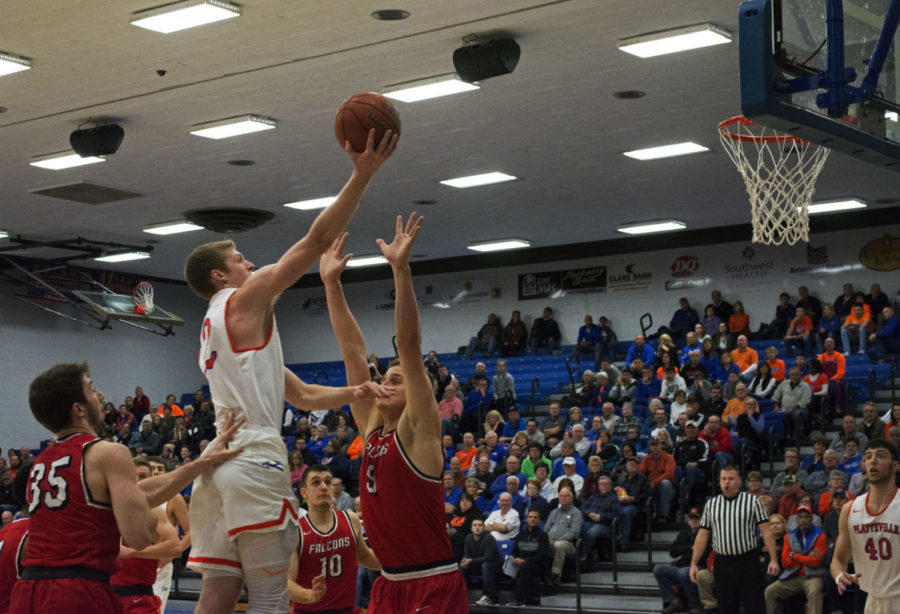 Robert Duax takes a jump shot against River Falls players.