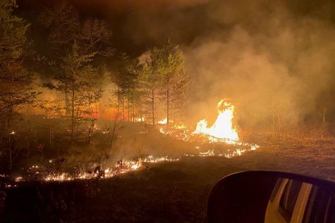 HOLD THE LINE - Firefighters operating under the joint command of
Fort McCoy and the DNR use backing fires to eliminate fuel for the
raging wildfire to use.