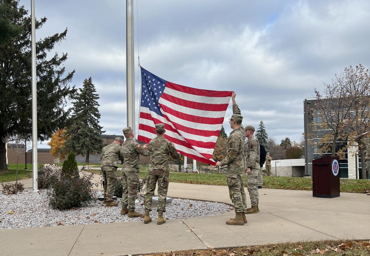 Active Military students raise the flag to honor veterans during the color gaurd ceremony