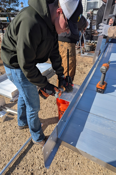 Quin, a member of UW-Platteville’s Farmhouse Fraternity chapter, prepares a section of a wheelchair ramp for a disabled veteran in Black Hawk Wisconsin.